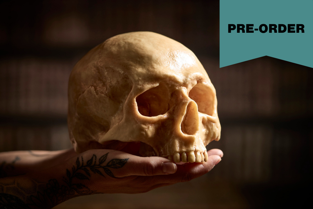 hand holds a realistic skull made of chocolate with banner reading pre-order